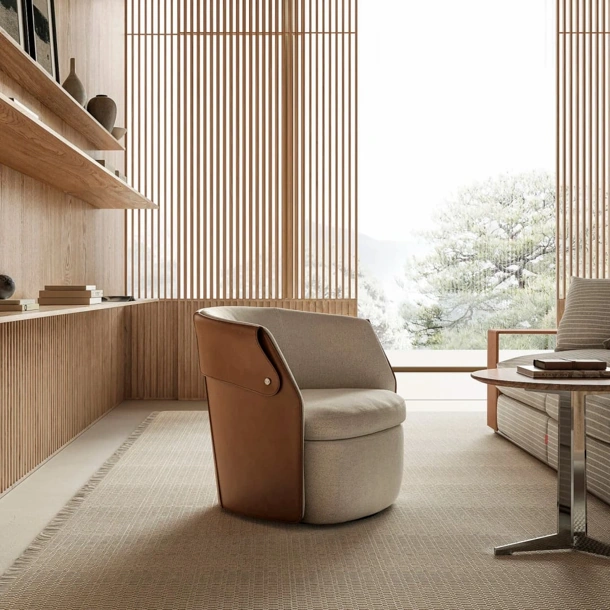 Poltroncina Ozzy in tessuto imbottito e cuoio di Flexform