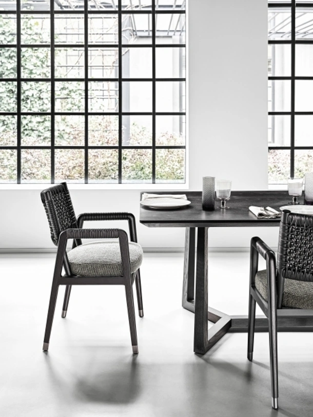 Sedia Ortigia con struttura in legno massello con schienale in cuoio intrecciato e seduta in tessuto imbottito di Flexform